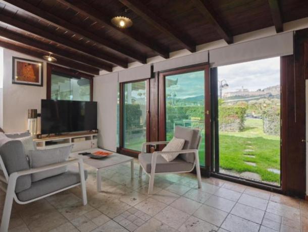 Sala appartamento-vacanze porta finestra giardino vista Assisi 