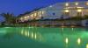Esterno hotel di notte con vista sulla piscina
