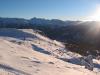 Sunlit skislopes on the hills, San Sicario