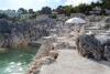 Spiaggia con Lettini e Ombrelloni tra gli scogli.